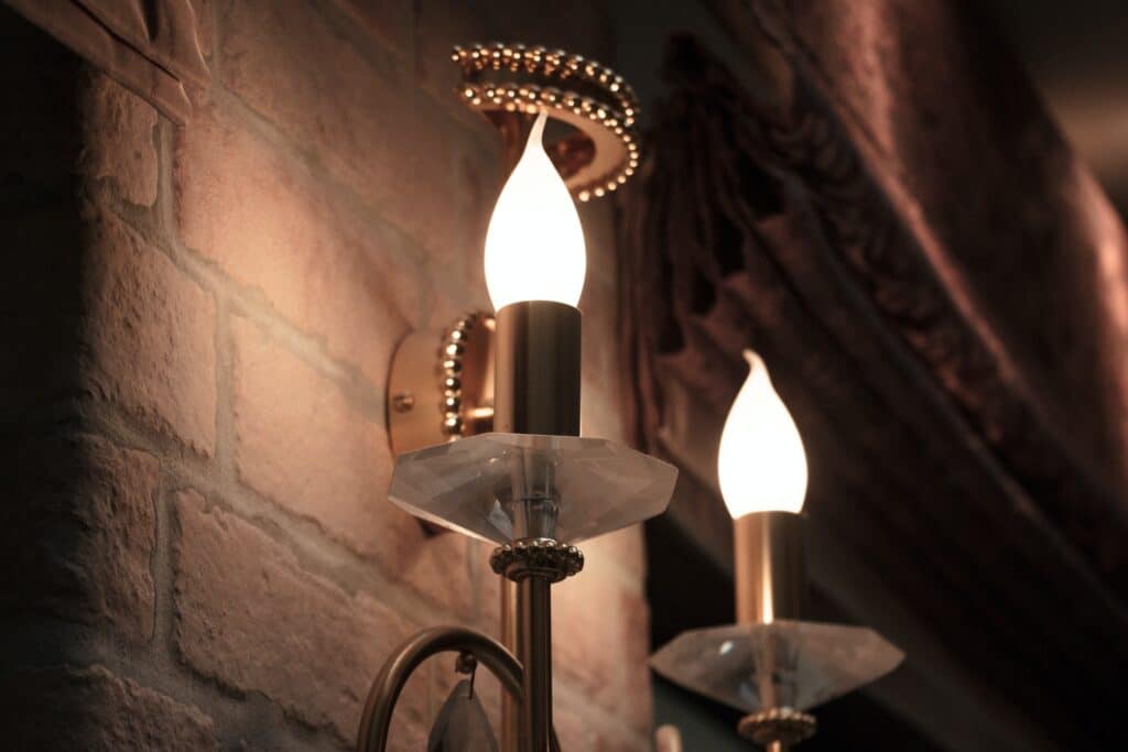 interior design - a light bulb in the form of candles hanging on a brick wall